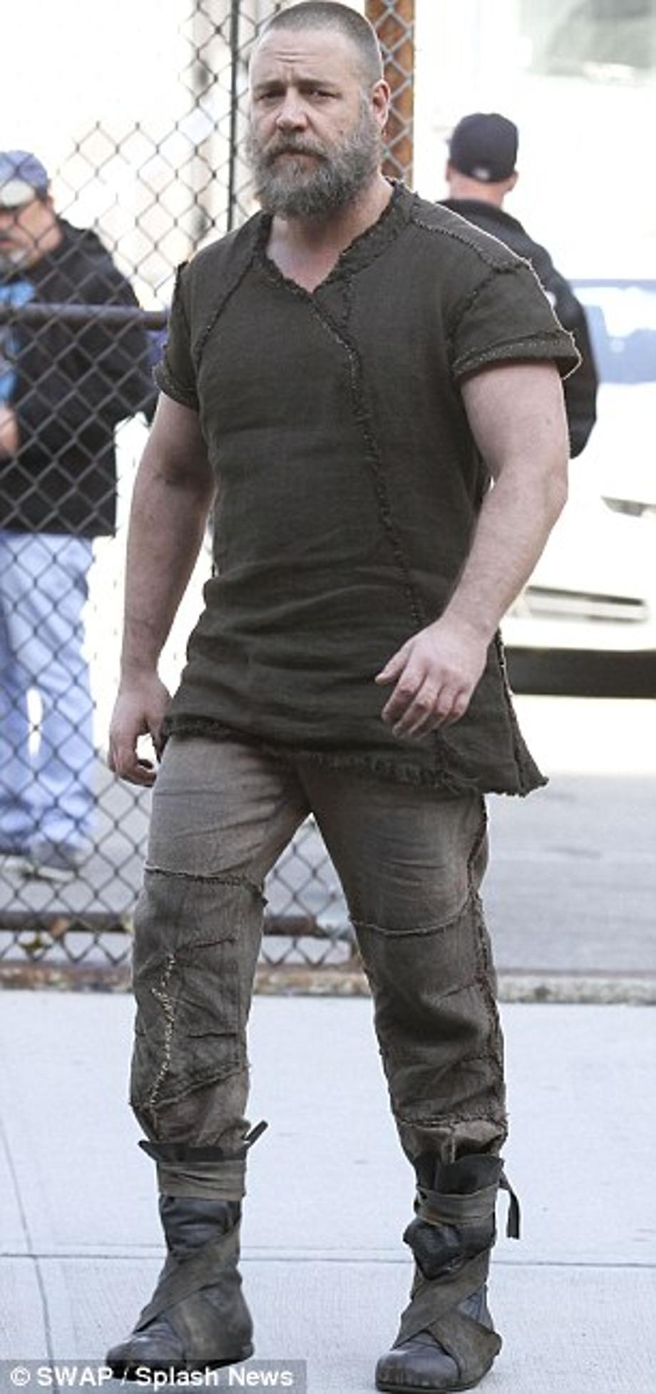 Beefed up: Russell looked muscular and stocky in his Noah costume as he strode around the Long Island set 