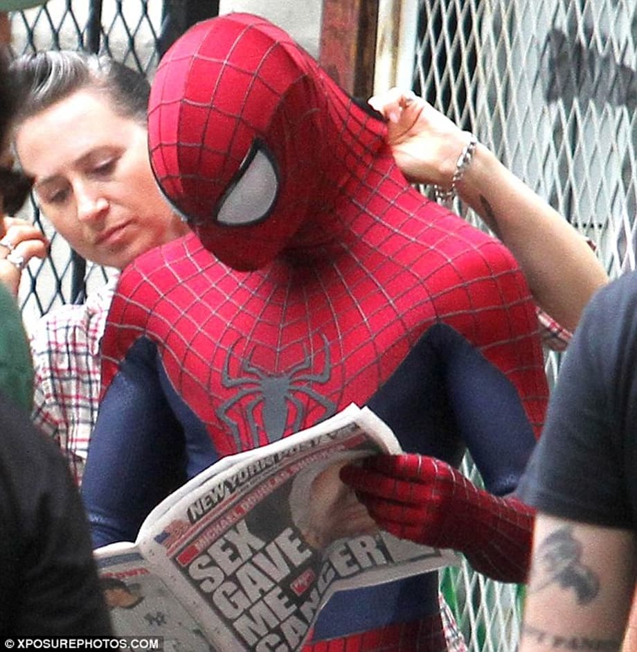 Reading the paper: Andrew in his Spider-Man outfit read the New York Post on Monday