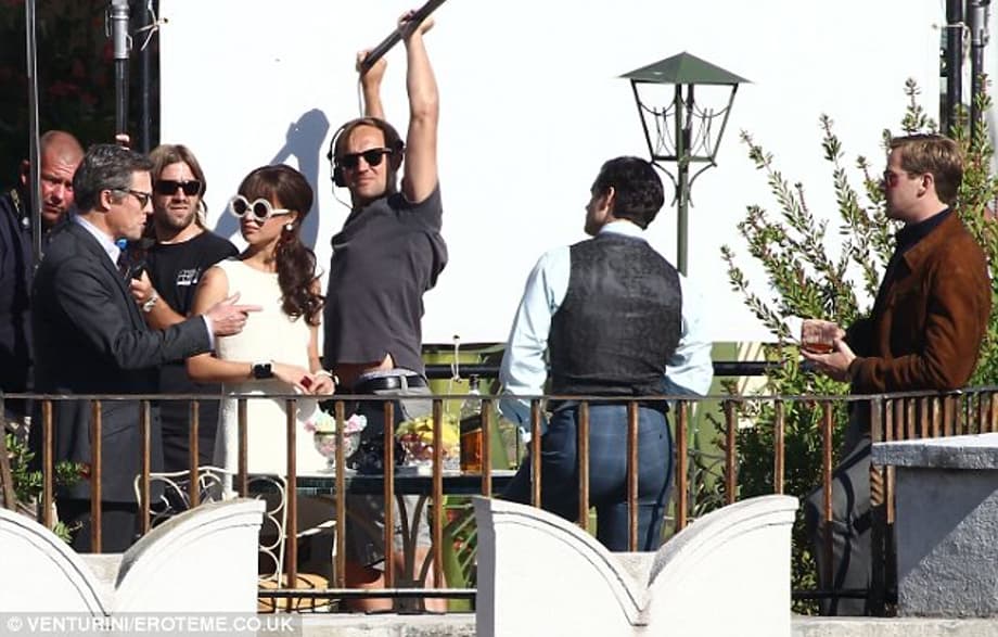 Hard at work: The Fifth Estate actress Alicia Vikander was also present for the scene, sporting a short white Sixties style dress and large white sunglasses