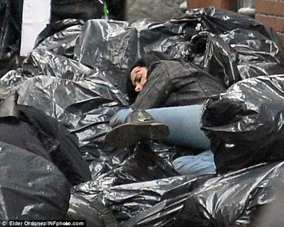 Recovering: Kristen ends up in a pile of garbage as she gets into the action on set