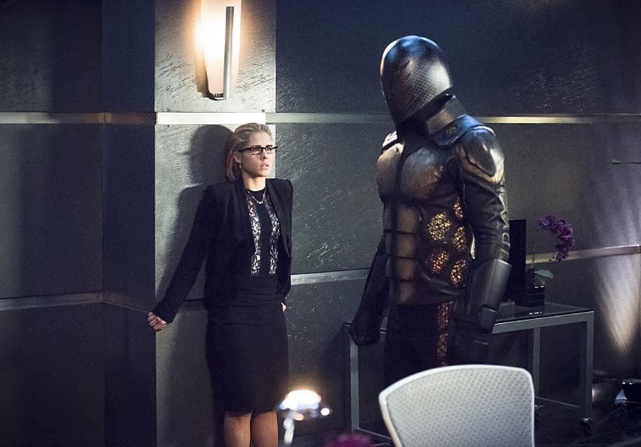 The Bug-Eyed-Bandit And Her Armored Henchman Attack Palmer Tech HQ In New ARROW Stills